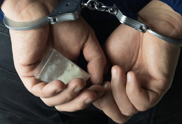 arrested-drug-dealer-handcuffs-package-600nw-1328265038