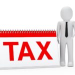 rag-doll-with-sign-that-says-tax-red_1156-234